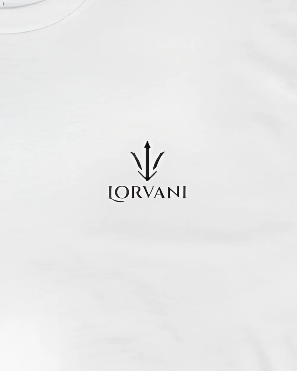 Close-up of the small black Lorvani logo on the white tee