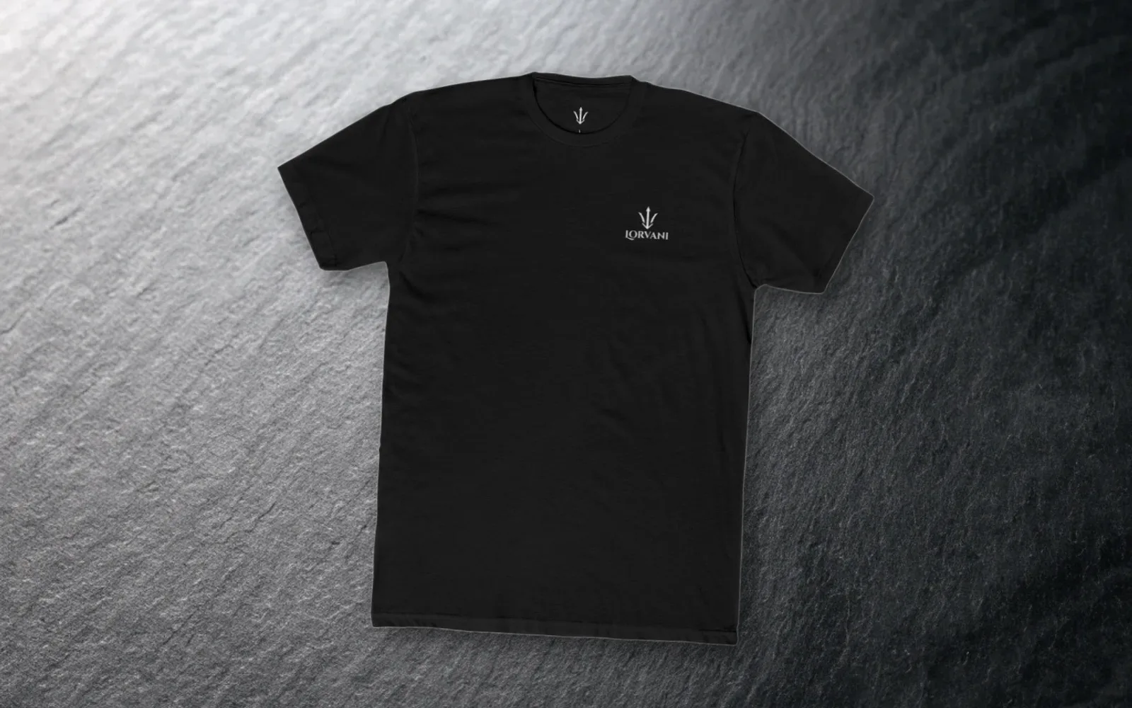 The black tee laid flat on dark slate