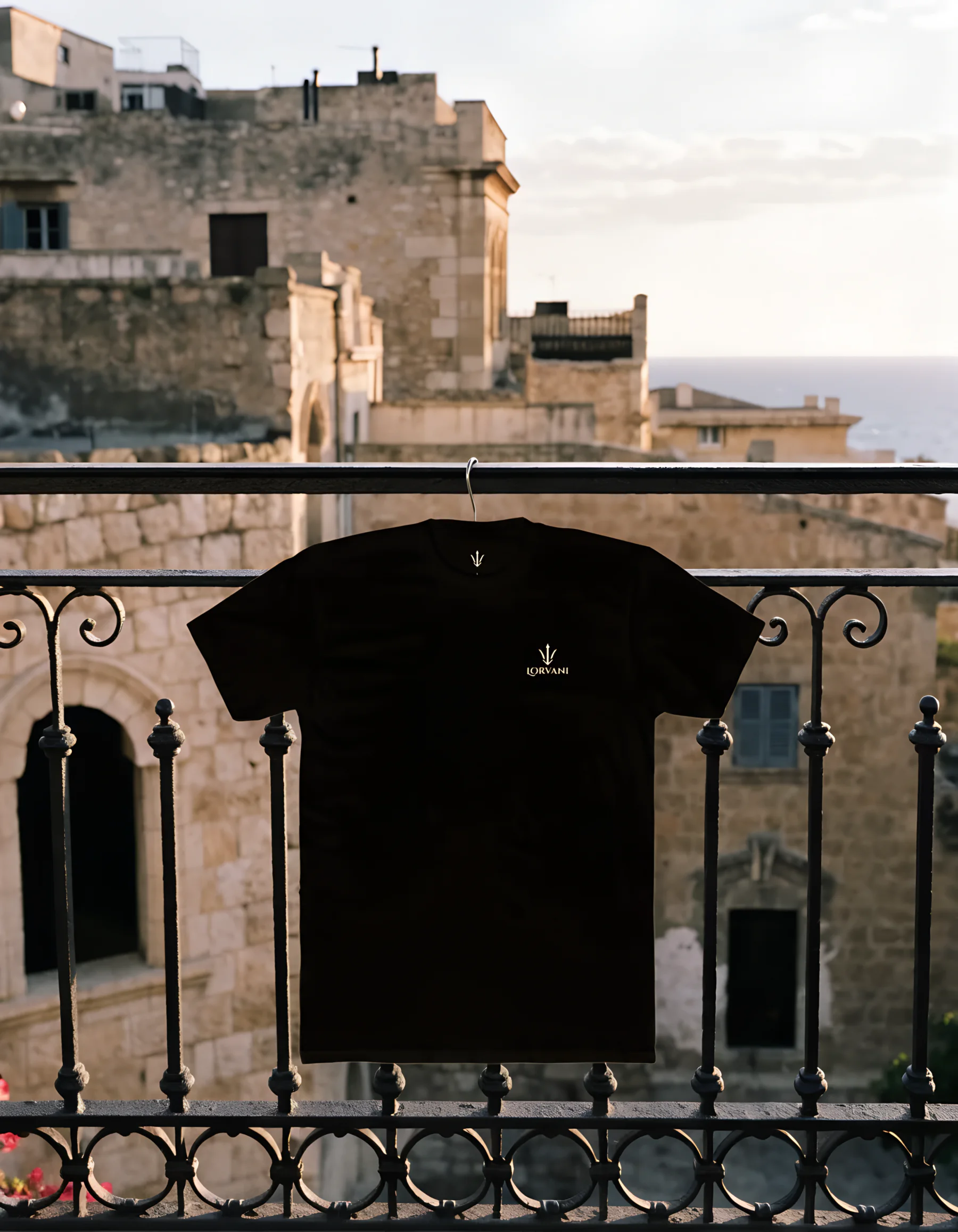 The black tee hanging from an old Beirut balcony at golden hour